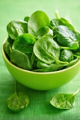 Fototapeta premium Fresh Spinach Leaves in Green Bowl