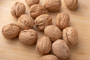 Walnuts, walnuts in their shells, and accessories positioned on a rustic table, Top view