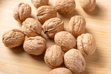 Walnuts, walnuts in their shells, and accessories positioned on a rustic table, Top view