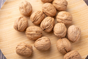 Walnuts, walnuts in their shells, and accessories positioned on a rustic table, Top view