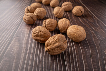 Walnuts, walnuts in their shells, and accessories positioned on a dark rustic table, Selective Focus.