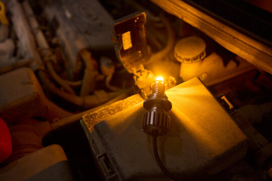 Careful precision is essential when installing a car headlight assembly for optimal performance - Powered by Adobe