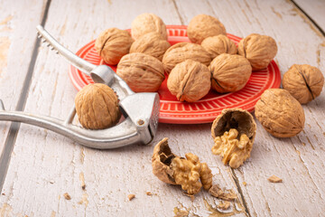 Walnuts, walnuts in their shells, and accessories positioned on a rustic table, Selective Focus.