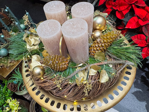 Festive centerpiece with candles, pine cones, and gold accents