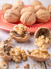 Walnuts, walnuts in their shells, and accessories positioned on a rustic table, Selective Focus.
