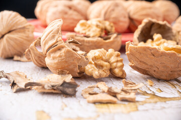 Walnuts, walnuts in their shells, and accessories positioned on a rustic table, Selective Focus.
