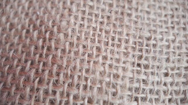 Rotating vintage burlap texture in a closeup static frame, ideal as a natural rustic background for holiday or craft visuals