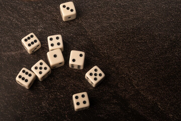 Dice thrown randomly onto a dark surface and dark background, Selective Focus.