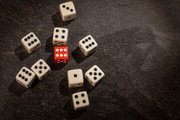 Dice thrown randomly onto a dark surface and dark background, Selective Focus.