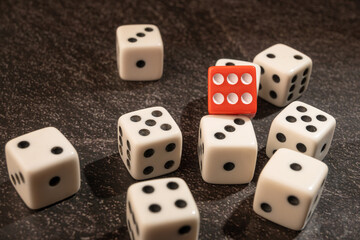 Dice thrown randomly onto a dark surface and dark background, Selective Focus.