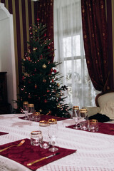 Preparing for the New Year. Decorating the table and Christmas tree at home