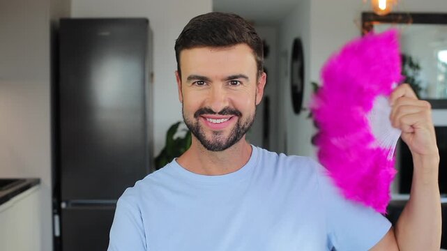 Arrogant man using a hand fan