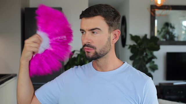 Arrogant man using a hand fan