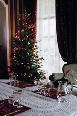 Preparing for the New Year. Decorating the table and Christmas tree at home