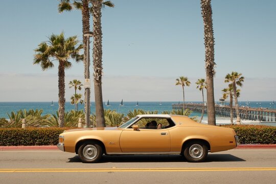 Vintage car and view of the pier and ocean, Oceanside, California