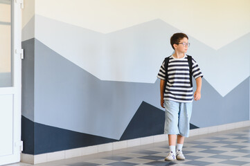 Schoolboy walking in school hallway during break time