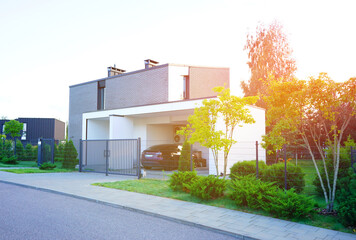Prefab modern house with garden at street. Stylish modern suburb house with white facade. Sunlight...