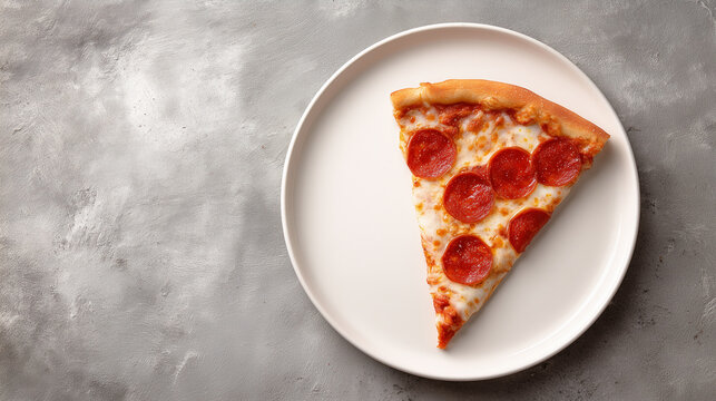 Pepperoni pizza slice on a white plate set against a gray textured background, photographed in soft natural light for simple, appetizing food imagery.