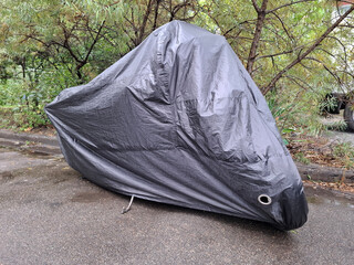 Black cover on a parked motorbike © Harmony Video Pro