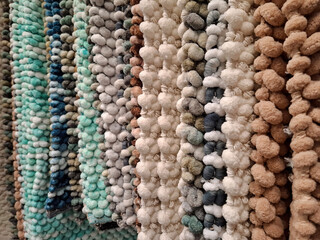 Small soft rugs hanging in shop window