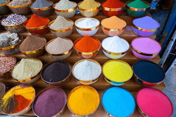 Traditional spices market. Pots and wooden tubs stand in row with colorful tea, spices, fruits, roots, flowers. Street bazaar. Dubai, UAE. Top view