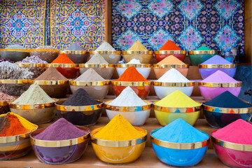 Traditional spices market. Pots and wooden tubs stand in row with colorful tea, spices, fruits, roots, flowers. Street bazaar. Dubai, UAE. 
