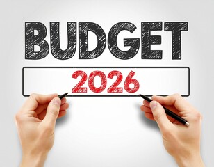 Budget 2026 concept with hands holding pens on a light background.