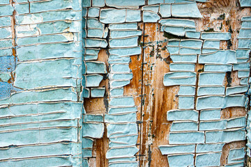 Old paint, plaster texture, peeling layers of paint close-up, concrete wall in need of repair