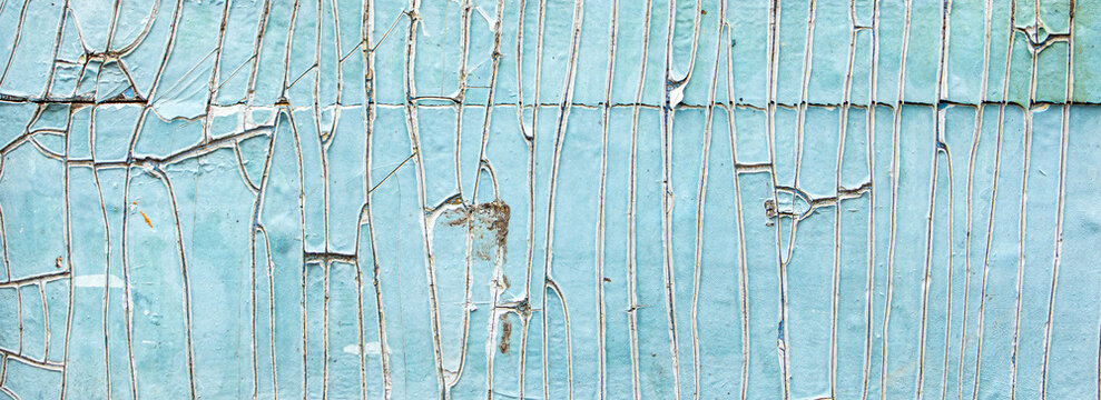 Old paint, plaster texture, peeling layers of paint close-up, concrete wall in need of repair