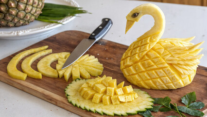 pineapple carved in the shape of a swan