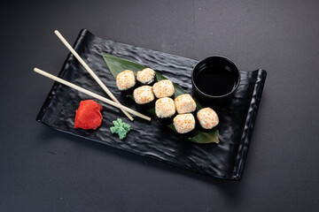 Japanese rolls, fish, black background