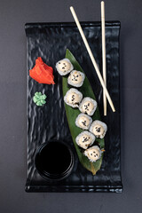 Japanese rolls, fish, black background