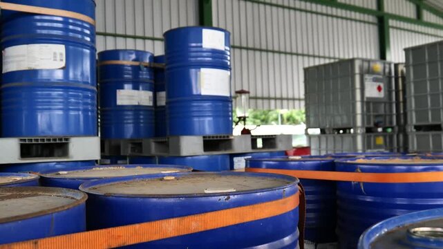 Chemical products warehouse with tiered racks storing chemical  barrels. The storage area belongs to a chemical factory and is organized inside warehouse. chemical industrial, logistic system, 