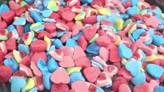 A close-up shot of a bowl filled with colorful candy hearts, great for Valentine's Day or romantic-themed designs