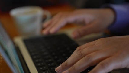 Typing on a Laptop Keyboard in a Cozy Cafe Setting to Enhance Business Productivity. Businessman or woman hands type on laptop keyboard.Hands touch typing on laptop notebook. Strategic Work Sessions.  - Powered by Adobe