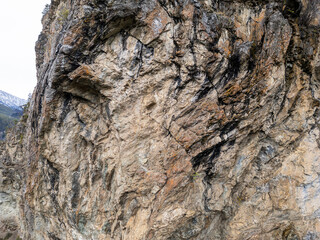 Rugged Rocky Cliff Face With Textured Crags Along Mountainous Terrain in BC