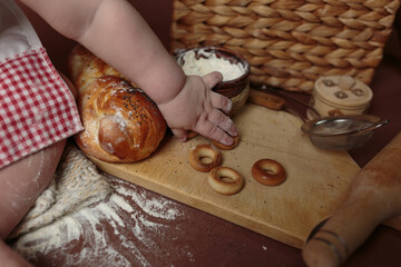 Little hands exploring baking ingredients and fresh bread