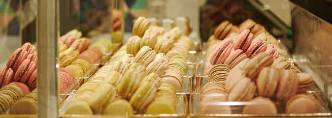 Variety of colorful macaroons displayed in a pastry shop case, showcasing delightful textures and vibrant colors for dessert lovers and food enthusiasts