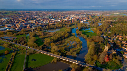 Wide aerial panorama of city, river, and flooded autumn plains