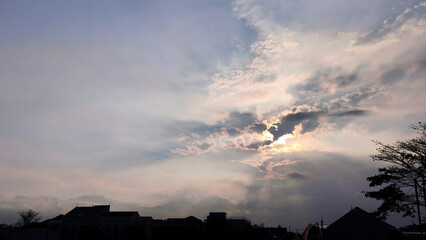 beautiful sunset view in a cloudy sky in the evening with houses below, panorama
