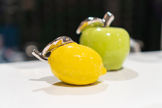 New Years Christmas decorations, three ceramic apples yellow, green, minimalistic modern design, smooth surfaces, sleek lines, glossy finish, texture variations, balanced composition