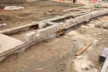 Construcion site of pavement granite cobblestone road in old city center installation or renovation repair.