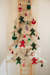 A handmade textile Christmas tree with felt gingerbread cookies