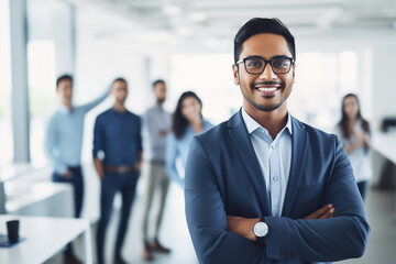 Smiling Confident Indian Business Man in Suit with Arms Crossed and Diverse Team Behind Him. for corporate team recruitment, diversity in leadership articles