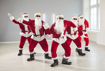 Happy Santas dance together, marking New Year or Christmas with party energy, blending...