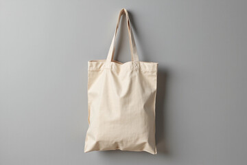 One eco bag hanging on grey wall. Mockup for design
