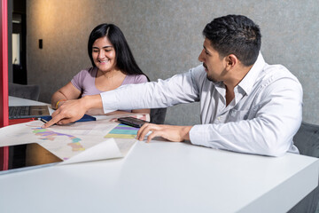 Sales agent assisting client discussing map details