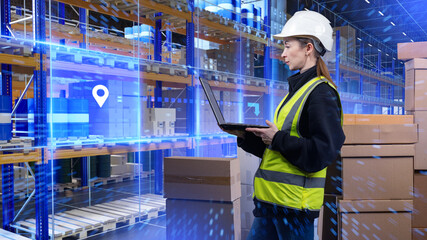 Warehouse worker uses a laptop to manage inventory with digital tracking tools, monitoring package...