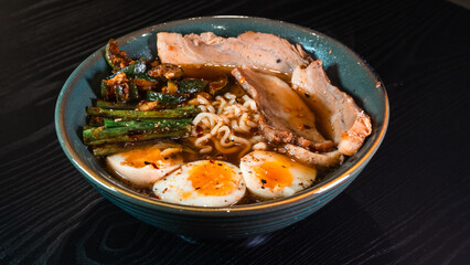 Delicious pork belly ramen with fresh asparagus, zucchini, and Nissin noodles. Rich broth, perfect comfort food. Quick and flavorful meal for Asian cuisine lovers.