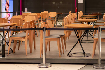 Empty cafe seating area blocked by stanchion
